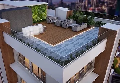 The rooftop of the Skylight boutique apartment building is designed as a premier amenity. It features a stylish bar, comfortable lounge seating, a green wall, and integrated lighting, creating a sophisticated space for residents to entertain and enjoy panoramic city views.