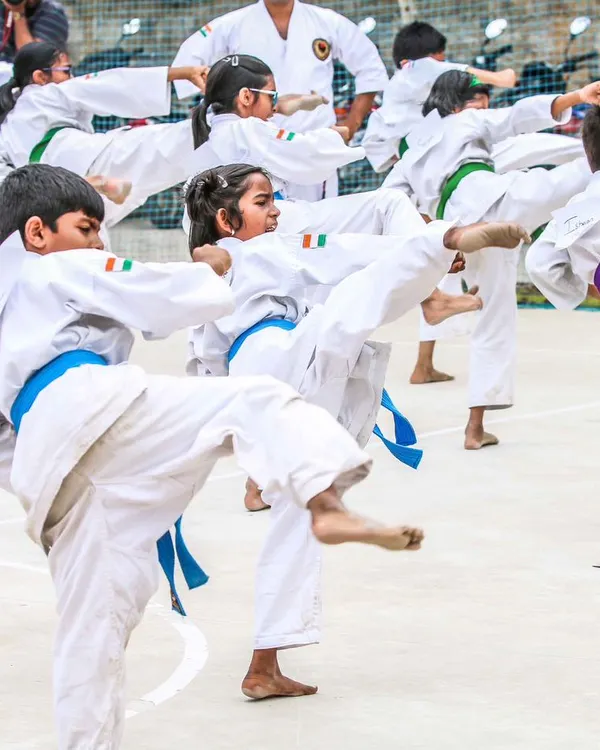 A group of our young students practicing front kicks in unison. This high-energy shot captures the discipline and enthusiasm of our kids' karate classes.