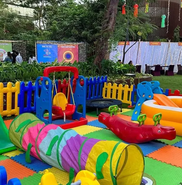 A complete outdoor soft play area I set up for a birthday party. It includes a safety fence, soft floor mats, a slide, a swing, a crawl tunnel, and an inflatable ball pit.