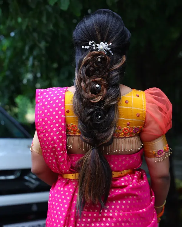 A back view of this stunningly intricate rose braid. This advanced hairstyle is a work of art and adds a modern, romantic touch to a traditional outfit.