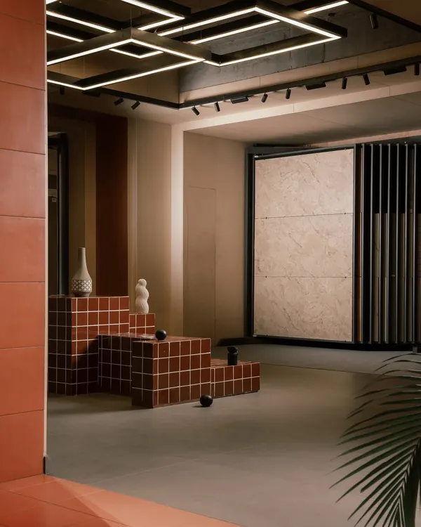 This corner of the Trove showroom was designed for discovery. The stepped, tiled platform serves as both seating and a real-world application of the product, while the large sliding display racks allow customers to focus on each tile collection without distraction.