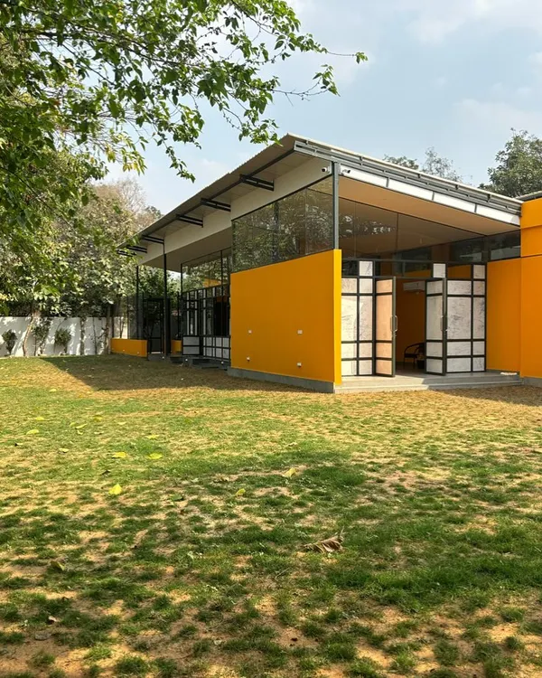 A look at our beautiful, modern facility on a sunny day. We designed the space with ample natural light, a spacious lawn, and secure enclosures to create a premium, happy environment for every dog.
