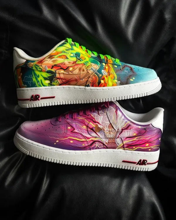 A pair of custom Nike Air Force 1s featuring a vibrant, full-color battle scene between Luffy and Zoro from One Piece. This is wearable art for true anime fans.