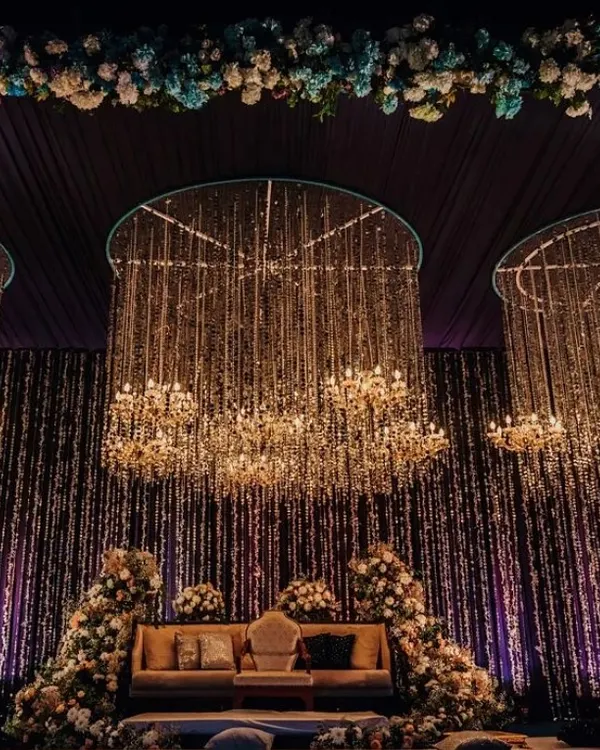 We design breathtaking stages that serve as the perfect backdrop for your most important moments. This setup for an awards night features cascading crystal chandeliers and dramatic lighting to create an atmosphere of pure opulence and success.