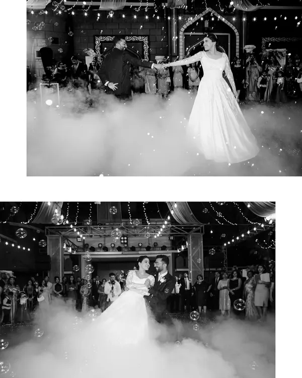 The couple's magical first dance, surrounded by clouds of smoke and the warm glow of fairy lights. This shot captures the romance and drama of the reception.