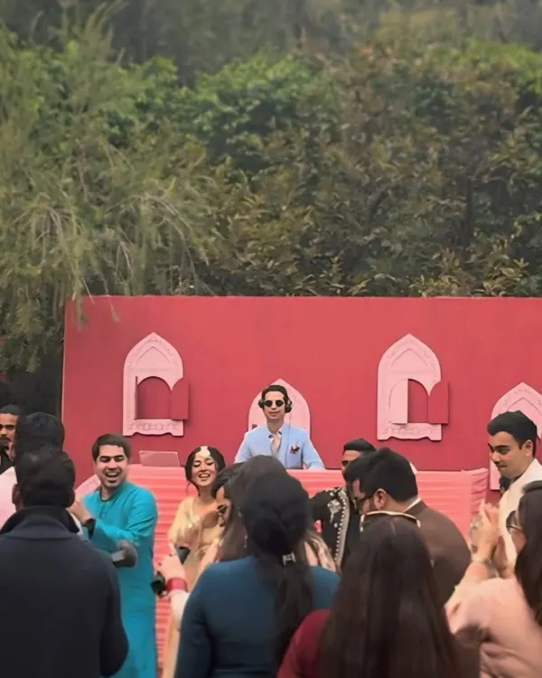 A beautiful daytime mehndi with a unique red and pink decor. I'm in the zone, playing tunes that get everyone twirling and smiling in the afternoon sun.