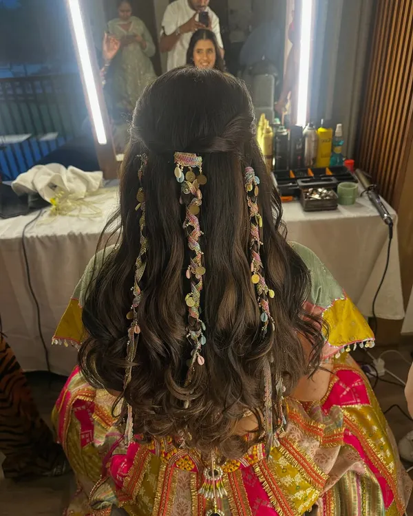 A truly unique and beautiful hairstyle for the modern bride. This look features soft waves with delicate, ribbon-like accessories woven through for a flowy and stunning effect.