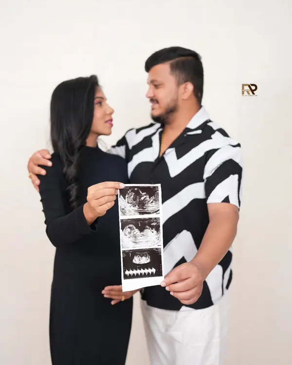 The first hello. We love incorporating your baby's first pictures into the shoot. This couple's portrait, featuring their ultrasound scan, is a deeply personal and emotional keepsake.