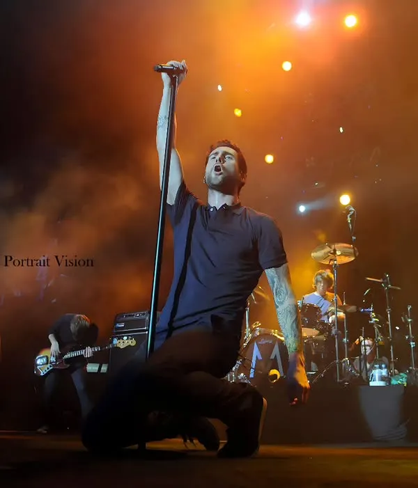Adam Levine of Maroon 5 during a powerful moment on stage. I captured this low-angle shot to emphasize his connection with the music and the energy he pours into his performance.