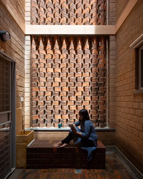 The play of light through this custom-designed brick jali screen creates a serene and contemplative atmosphere. The intricate pattern is a testament to the skill of the masons and the versatility of brick as a material.