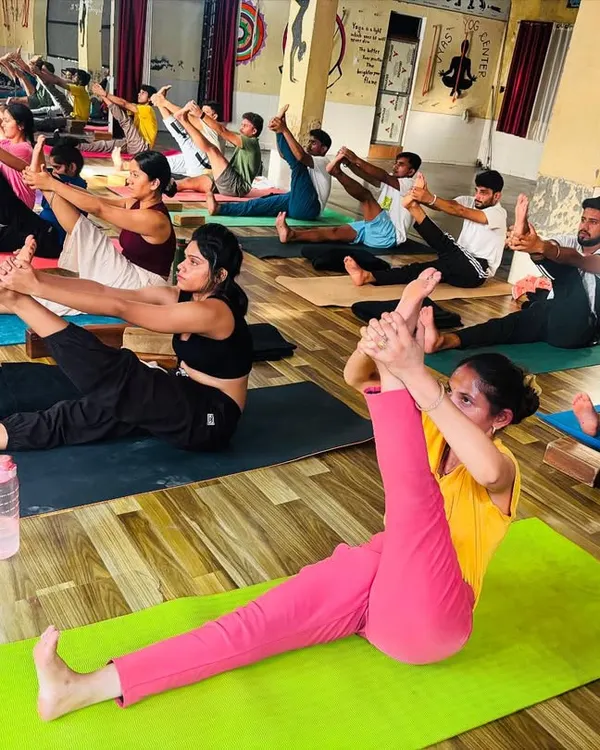 A snapshot from our group yoga class, with students practicing a seated leg stretch. The energy of practicing together is powerful, and we ensure everyone gets the guidance they need.