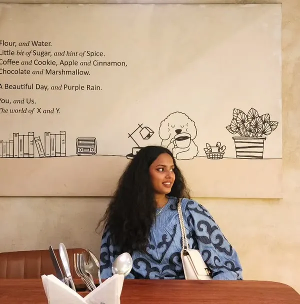 A casual cafe outing. I'm wearing a comfortable printed blue top that's stylish yet relaxed. This is a great example of an easy, everyday look that I can help you build from your own closet.