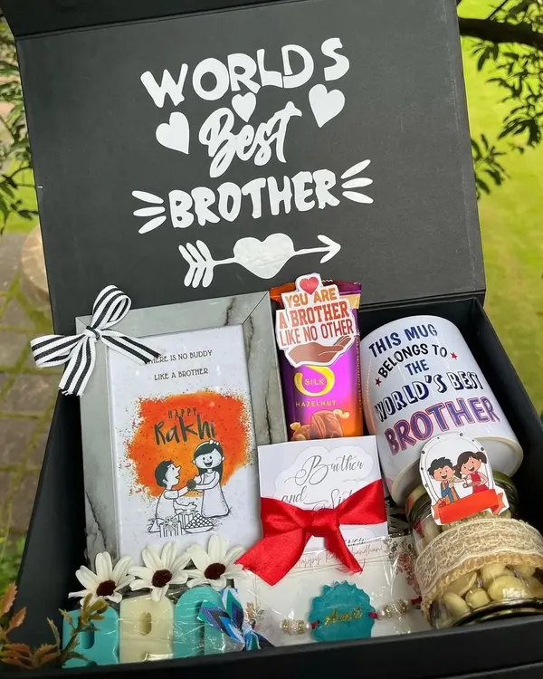 A "World's Best Brother" hamper that truly lives up to its name. This large gift box is filled with a custom mug, photo frame, chocolates, a personalized rakhi, and other treats.