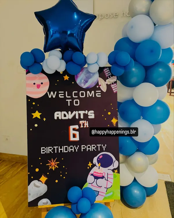 A personalized welcome sign is the perfect way to greet guests. This space-themed sign for Advit's 6th birthday features cute graphics and is flanked by balloons that match the party's color scheme.