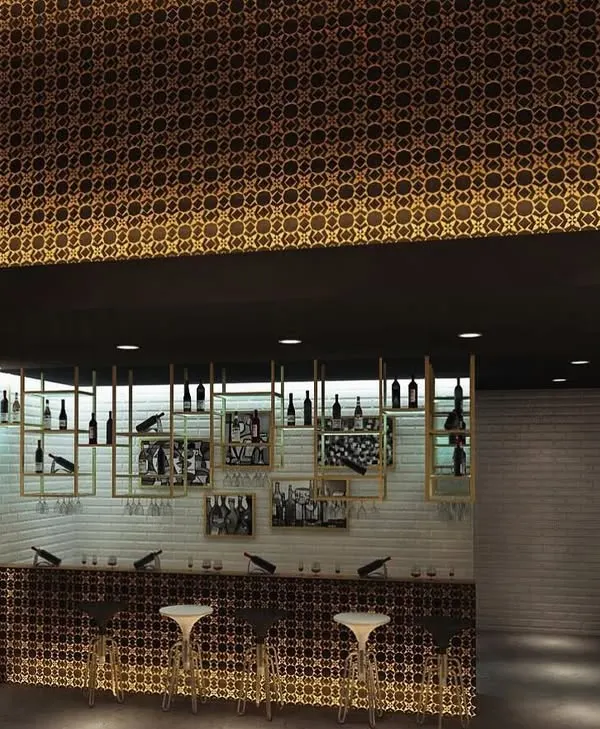 A concept for a sophisticated smoke lounge and bar area. The design features a dramatic gold patterned ceiling, custom bottle displays, and elegant bar seating.