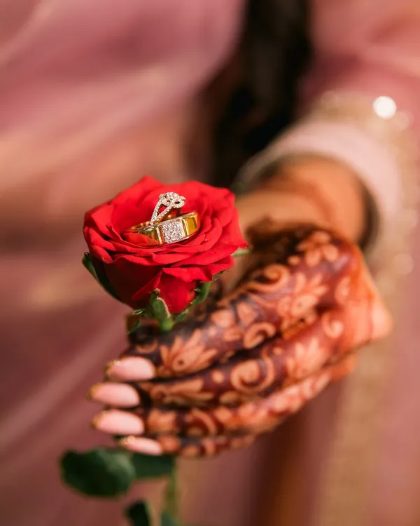 A creative and romantic shot of the engagement rings placed inside a vibrant red rose. We love finding unique ways to photograph these important symbols of your commitment.