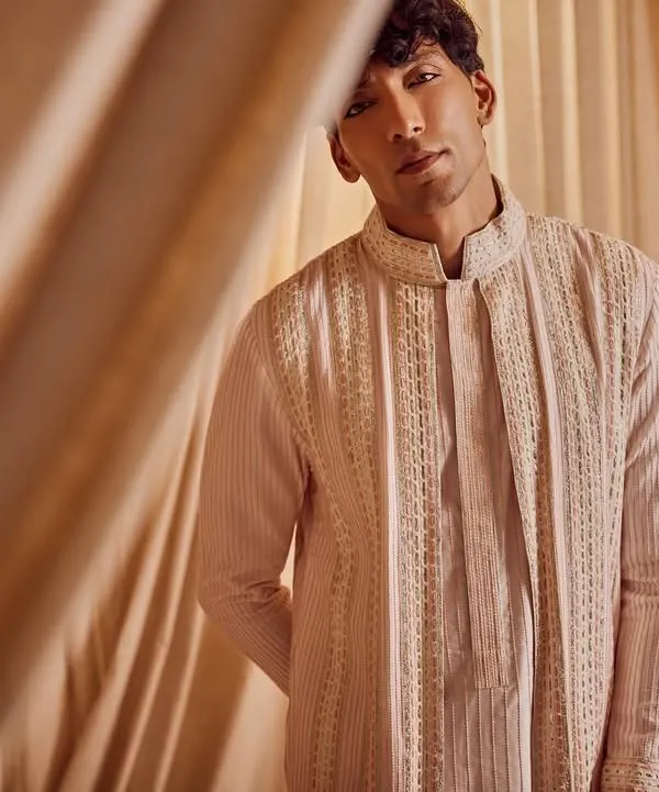 A portrait from a campaign for menswear designer Kunal Anil Tanna. The grooming is focused on creating a flawless, matte complexion and defining the brows for a look that is both strong and natural.