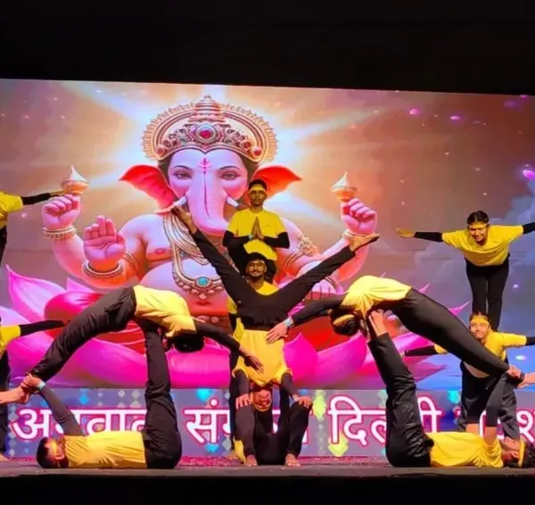 This is what teamwork and dedication look like. My students are performing an advanced group formation on stage, showing the incredible strength, balance, and trust they build in my classes.