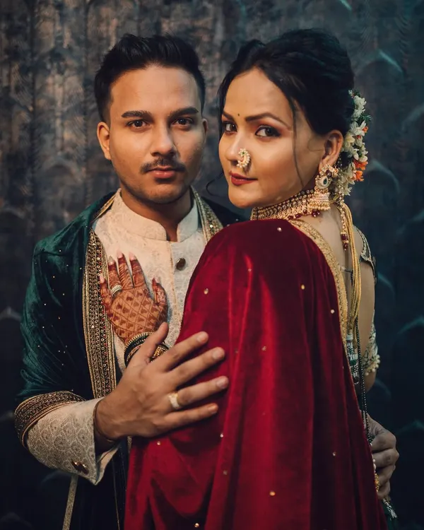 A powerful and intimate royal-themed couple portrait, showcasing a deep connection with moody, cinematic lighting and rich, traditional attire.