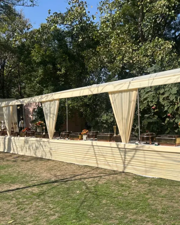 A beautiful daytime event setup in a lush green lawn. Our long, covered buffet station ensures food stays fresh while blending elegantly with the outdoor environment.