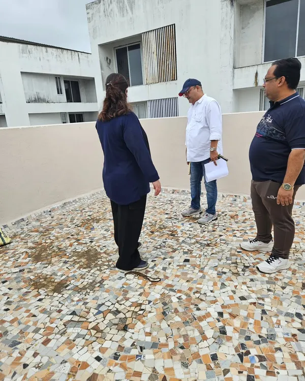 Consulting with clients on the terrace of their home. Even outdoor spaces like balconies and terraces have Vastu significance and impact the home's overall energy.