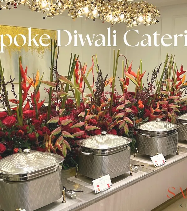 A bespoke Diwali catering setup featuring a stunning floral centerpiece and elegant silver chafing dishes. I design each buffet to be a feast for the eyes as well as the palate.