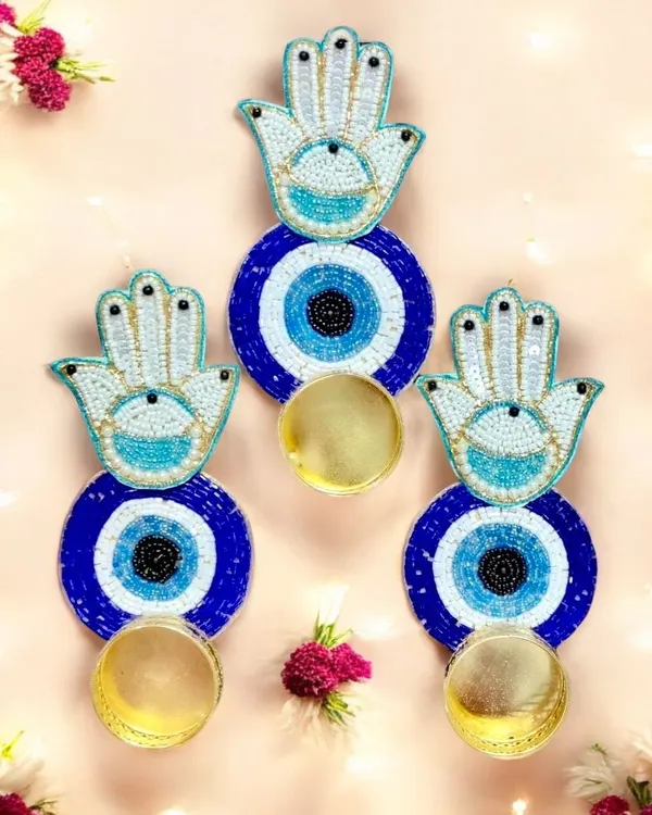 These Hamsa Hand and Evil Eye wall hangings with attached diya holders are perfect for warding off negativity. They are a beautiful and meaningful addition to any festive decor or as a thoughtful gift.