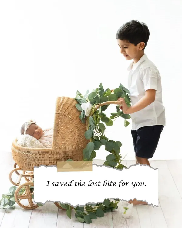 "I saved the last bite for you." A big brother looks lovingly at his newborn sister in her bassinet. Sibling photoshoots are a beautiful way to welcome a new baby into the family.