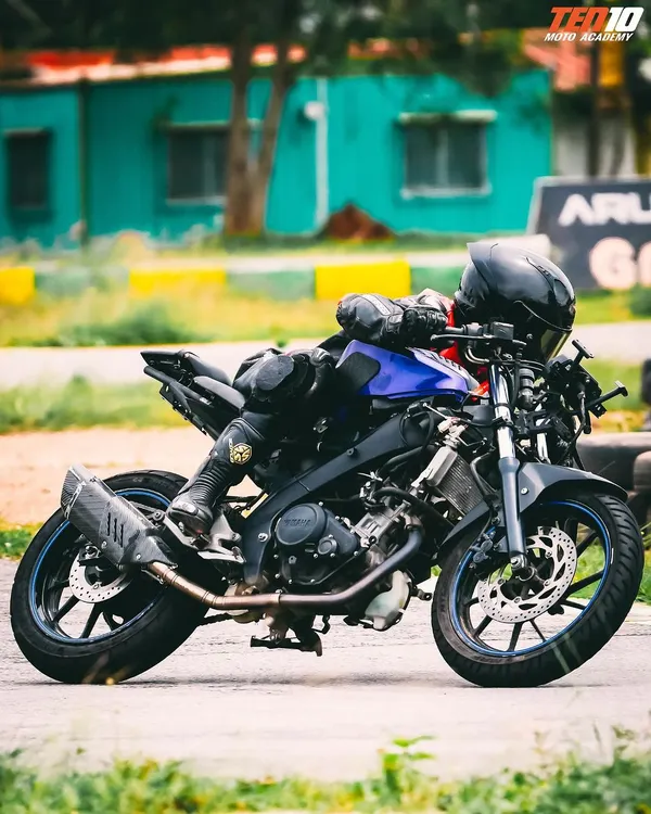 Here, a rider practices a deep lean, a core skill for advanced cornering. We teach you how to build up to this level of control safely, ensuring your bike and body work together as one.