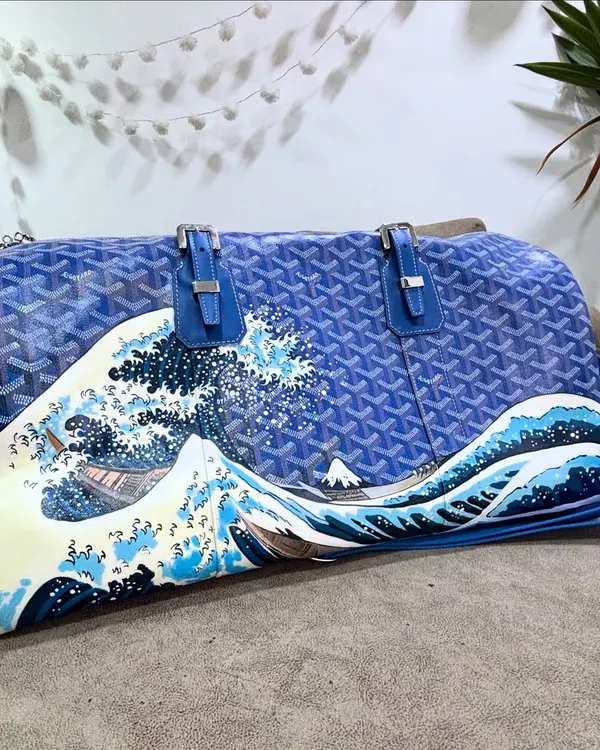 This is one of my all-time favorite projects. I hand-painted 'The Great Wave off Kanagawa' on a blue Goyard duffle bag, transforming it into a piece of wearable art history. The detail required a lot of patience, but the result was so worth it.