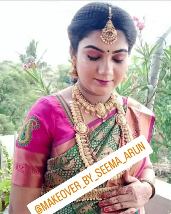 A serene and beautiful makeover for a baby shower. The makeup is soft and glowing, and the look is completed with traditional jewellery and a perfectly draped silk saree.