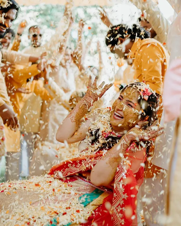 An explosion of joy and flower petals! We love capturing the peak moments of a Haldi ceremony, where the bride is showered with love and blessings in the most vibrant way.