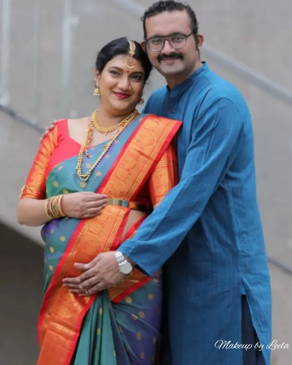 A heartwarming photo of a couple at their baby shower. The mother-to-be is glowing with a soft makeup look that highlights her happiness.
