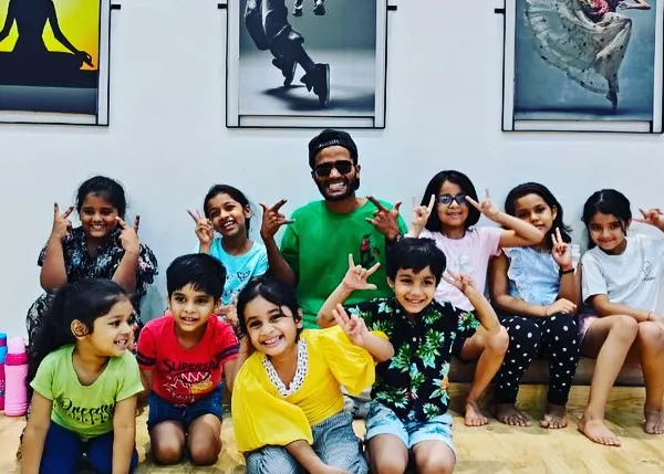 A happy moment with my amazing junior dancers after a fun Hip-Hop routine. I love seeing them grow as performers and as a team.