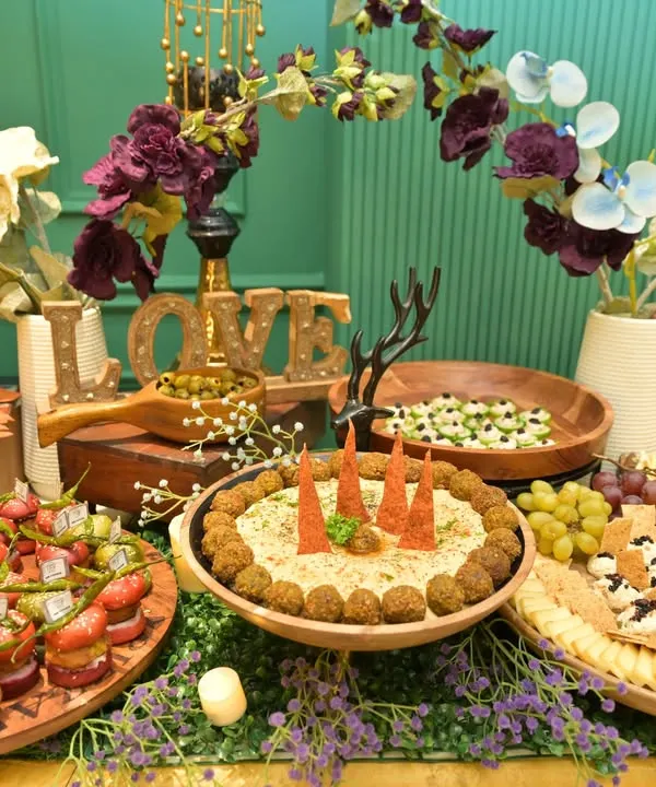 A beautiful example of our grazing table artistry, combining savory and sweet elements. Notice the mix of fresh fruits, cheeses, dips, and canapés, all arranged to invite guests to explore and indulge.
