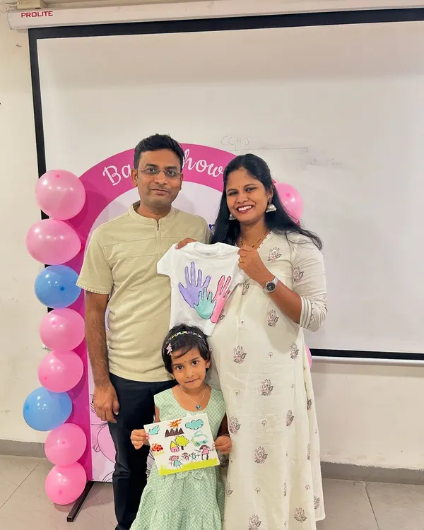 A beautiful family photo from a baby shower celebration we hosted at Aster Hospital. The family created personalized keepsakes like a painted baby t-shirt and canvas art.