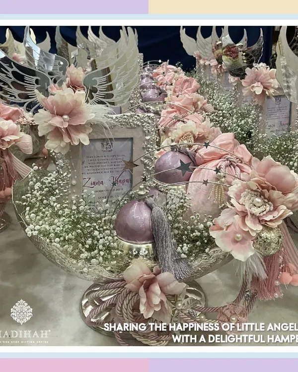 A beautiful silver platter arrangement to announce the arrival of a little angel. This hamper features delicate pink floral details, baby's breath, and charming angel wing accents, creating a heavenly and memorable baby girl announcement.