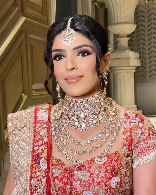 This is the look that makes my heart sing. A classic bridal portrait focusing on flawless, radiant skin and captivating eyes, framed by traditional jewelry. It’s about enhancing your natural beauty to create a timeless memory.