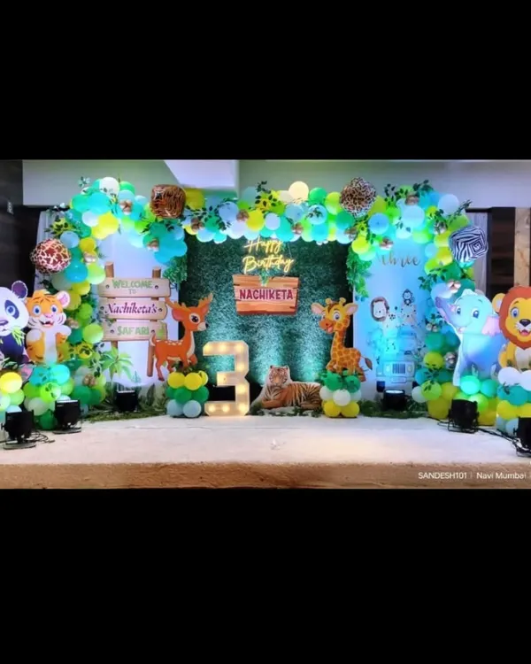 A vibrant jungle safari theme for a 3rd birthday. This stage features a variety of cute animal cutouts, a lush green backdrop, and a wooden sign, creating a welcoming and fun atmosphere for the little explorer.