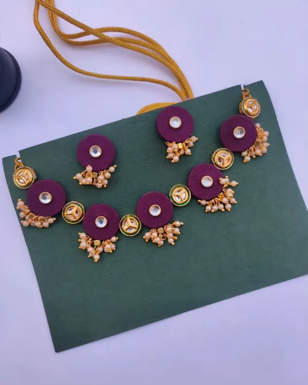 This beautiful kundan necklace set is made with deep purple fabric patches and delicate pearl clusters. I can customise the colour of the fabric to match your wedding or party outfit.
