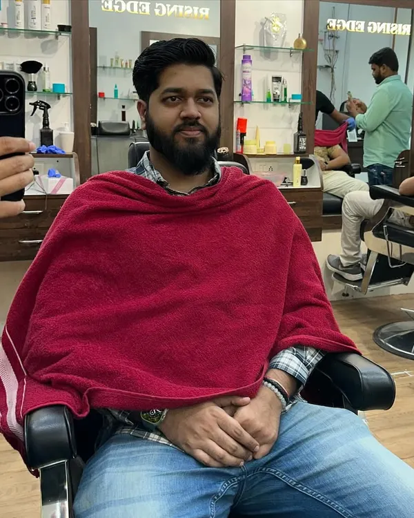 Dapper and delighted. A happy client relaxing in the chair after his grooming session, reflecting the comfortable experience I strive to provide.