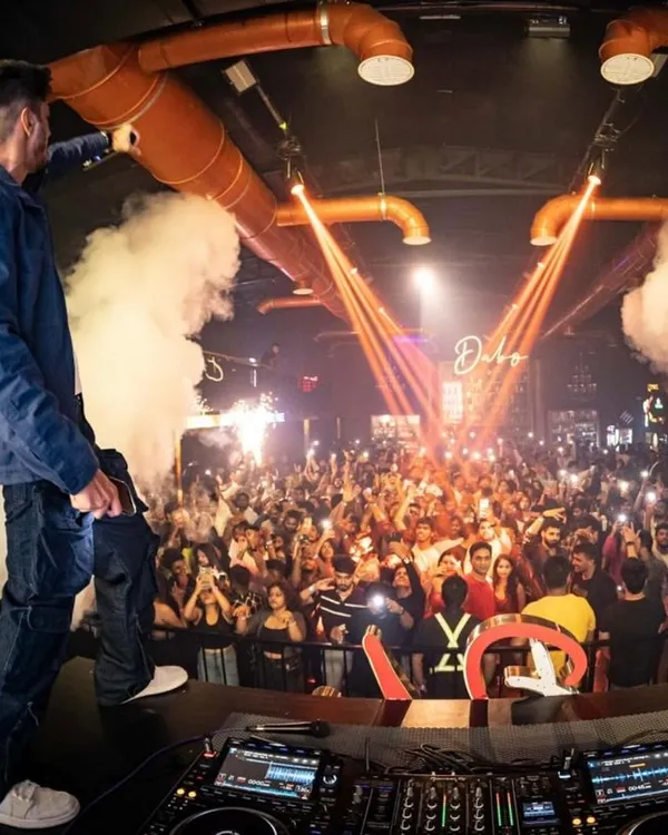 This is what pure energy looks like. Standing above a sea of lights at a packed New Year's Eve party, I live for moments like this. This is the festival-level energy I bring to every gig.