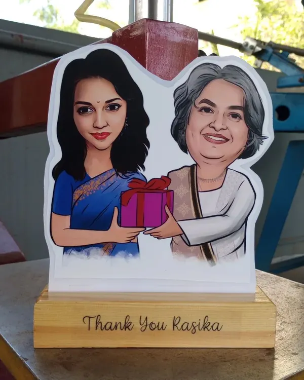 A beautiful caricature cut-out on a wooden stand, personalized with a 'Thank You' message. These make wonderful and heartfelt gifts for mentors, teachers, or colleagues.