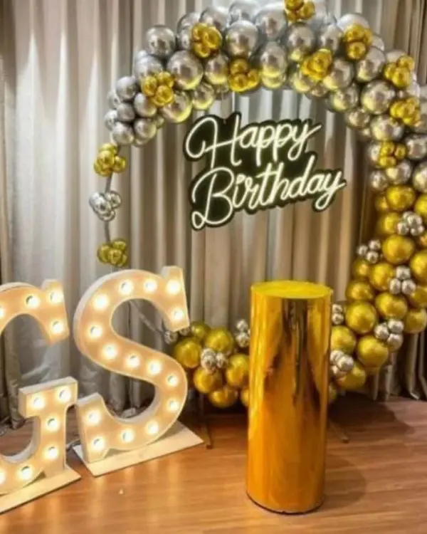 For a truly special birthday, I offer these premium setups. This one includes a full ring of metallic gold and silver balloons, a bright "Happy Birthday" neon sign, and large, light-up marquee letters for the initials. It's a glamorous photo backdrop perfect for milestone birthdays.