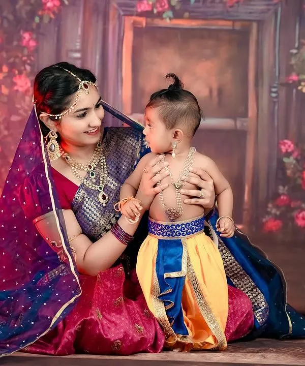 The timeless love of Yashoda and her little Krishna. We created this beautiful themed portrait to celebrate a mother's bond, using traditional attire and a rich, floral backdrop.