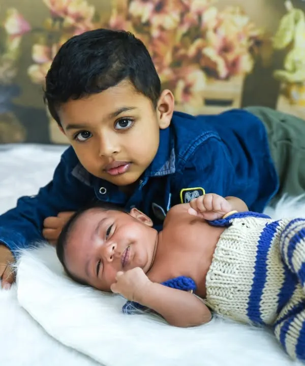 The beginning of a lifelong friendship. Capturing the gentle love between an older brother and his new baby sibling is one of our favorite moments.