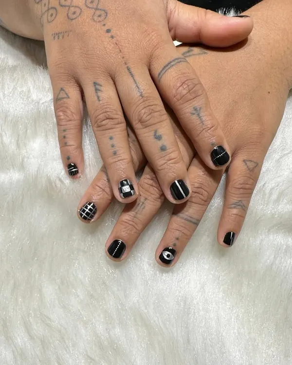Black is never basic. For this client, I created a unique set of hand-painted monochrome designs, including grids, stripes, and an evil eye, to match his tattooed hands.