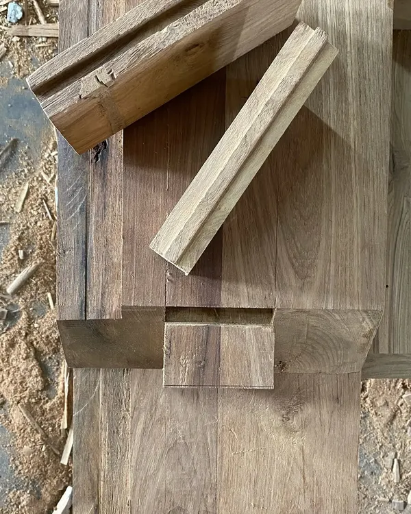 A detailed look at the wood joinery for a piece of custom furniture. This image shows the precision of a half-lap joint, a technique we use to ensure strength and durability in our bespoke designs.