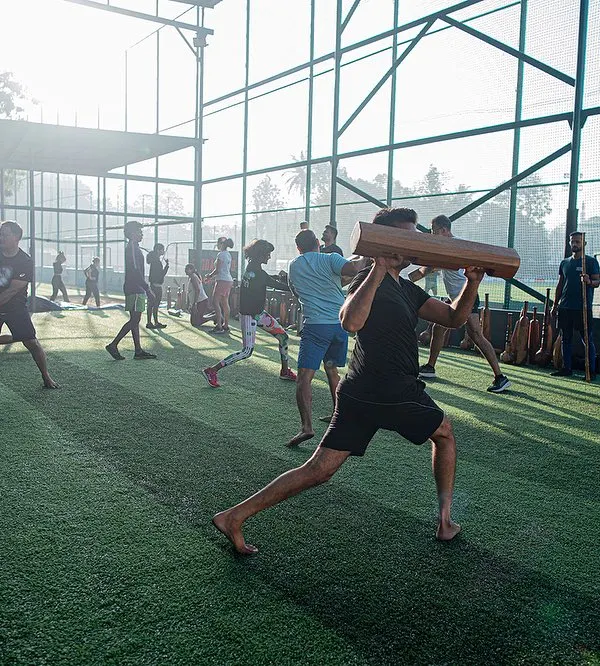 A wide shot of a bustling group session on the turf. This image perfectly captures the energy, scale, and community spirit of our workouts, with members of all levels training together.