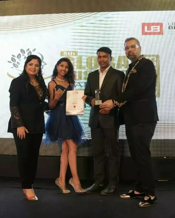 Receiving a trophy at the 5th Global Business Leadership Awards, a recognition of our contribution to the industry.